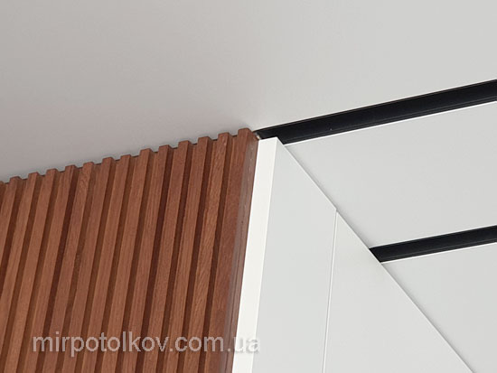 натяжной потолок и деревянные рейки на стене